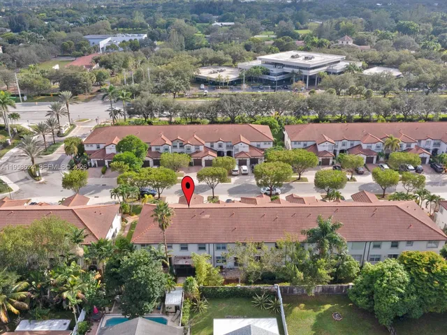 a front view of a house with a yard and potted plants