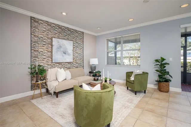 a living room with furniture potted plant and window