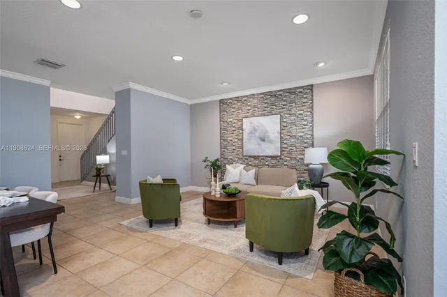 a living room with furniture and a potted plant