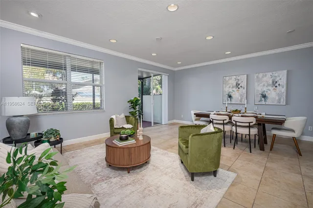 a living room with furniture potted plant and window