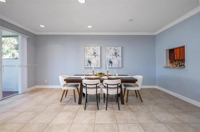 a dining room with a wooden table and chairs