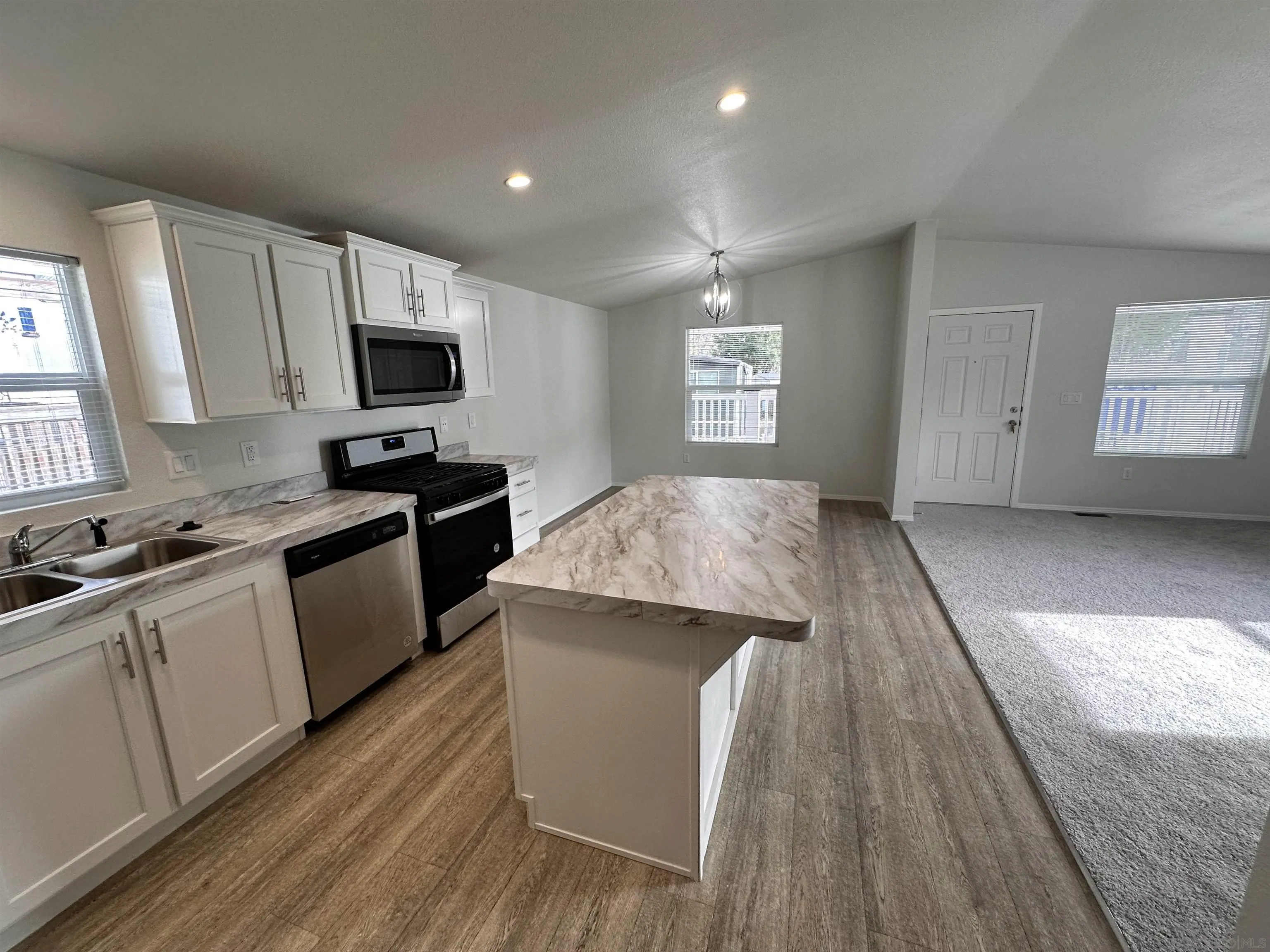 a kitchen with a sink stove top oven and microwave