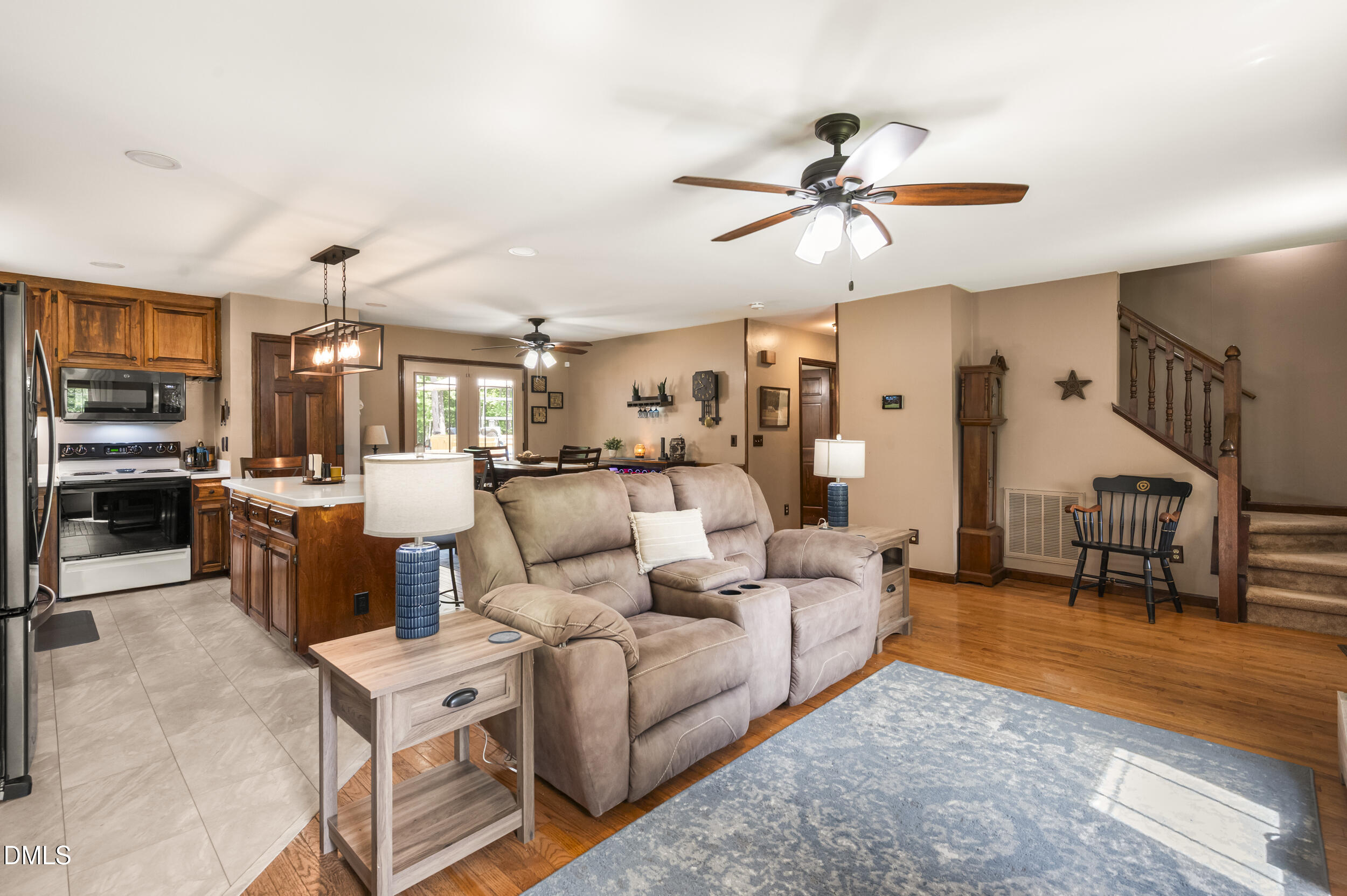 4209 Lassiter Road Wake Forest, NC 27587 - Photo 22 of 39 a living room with furniture kitchen view and a chandelier