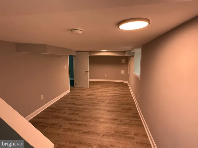 a view of hallway with wooden floor