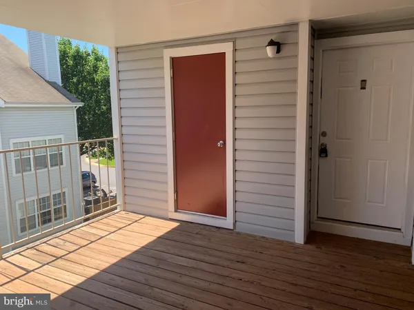 a view of a balcony with wooden floor