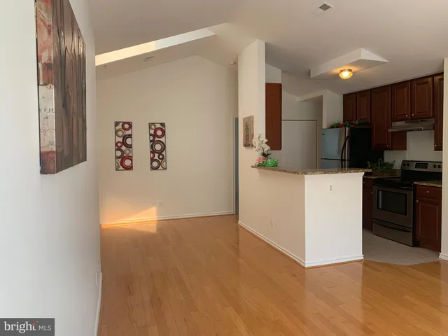 a kitchen with stainless steel appliances a refrigerator and a stove top oven