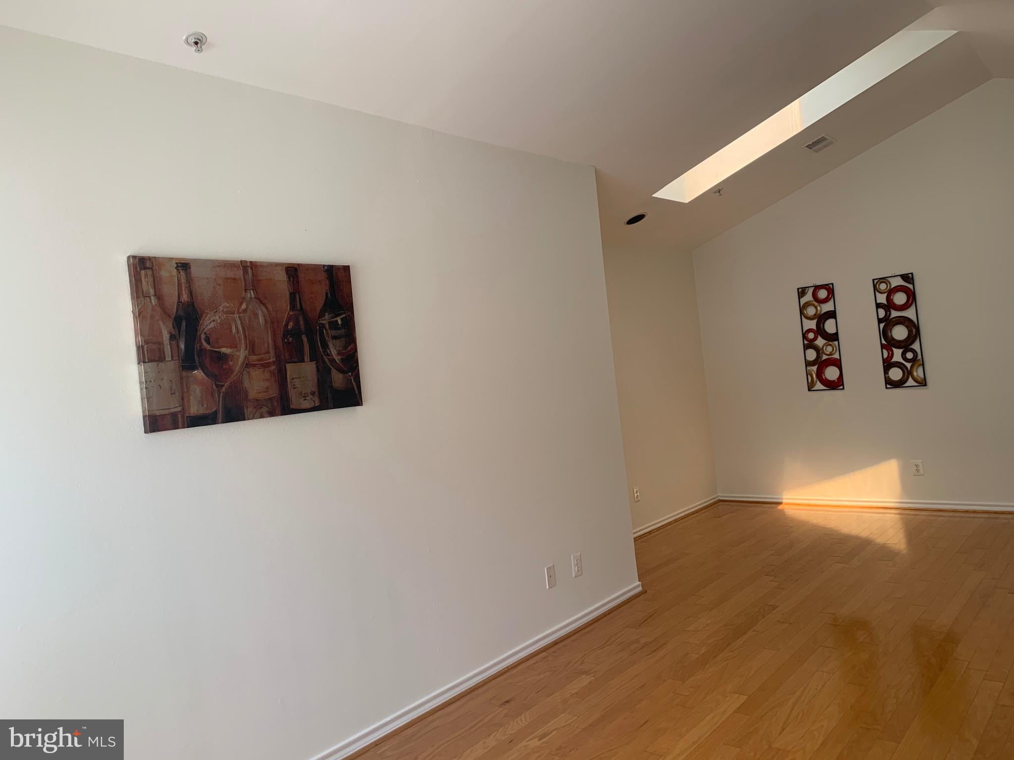 18533 Boysenberry Drive, Unit 288212 Gaithersburg, MD 20879 - Photo 10 of 17 a view of a wall with wooden floor