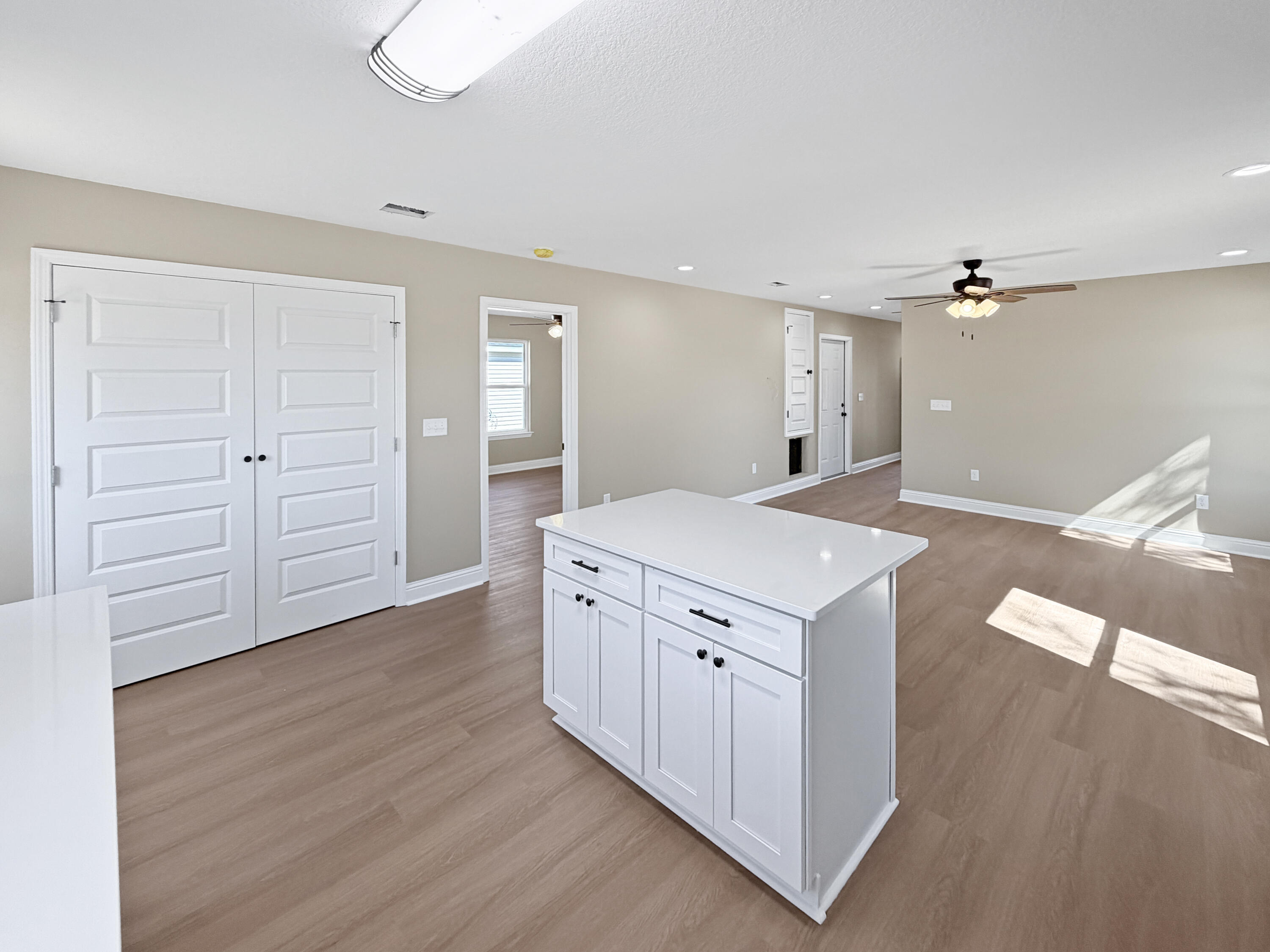 5356 Highview Drive Crestview, FL 32539 - Photo 12 of 18 wooden floor with white cabinets and wooden floors