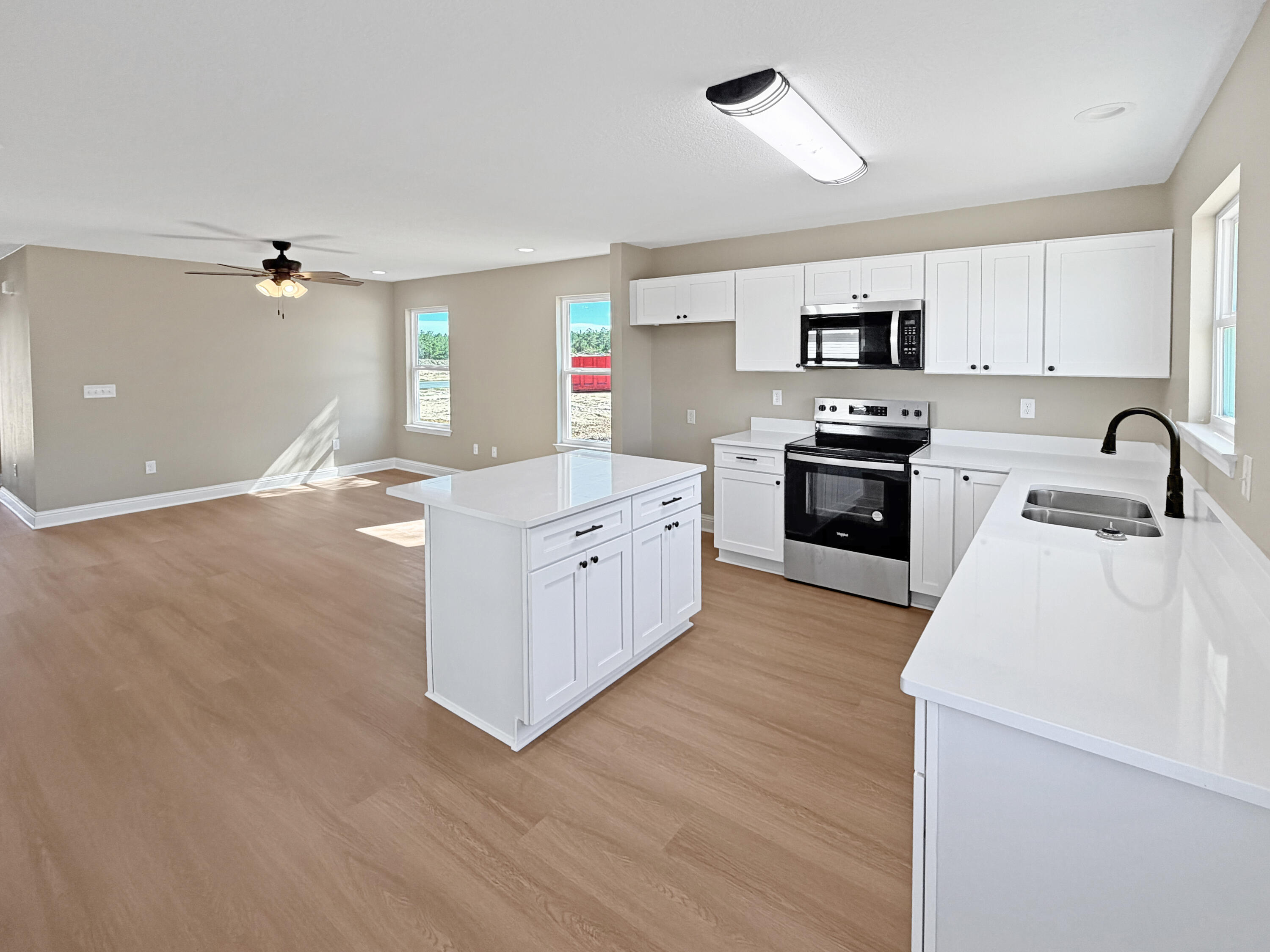 5356 Highview Drive Crestview, FL 32539 - Photo 6 of 18 a kitchen with stainless steel appliances granite countertop a sink stove and refrigerator