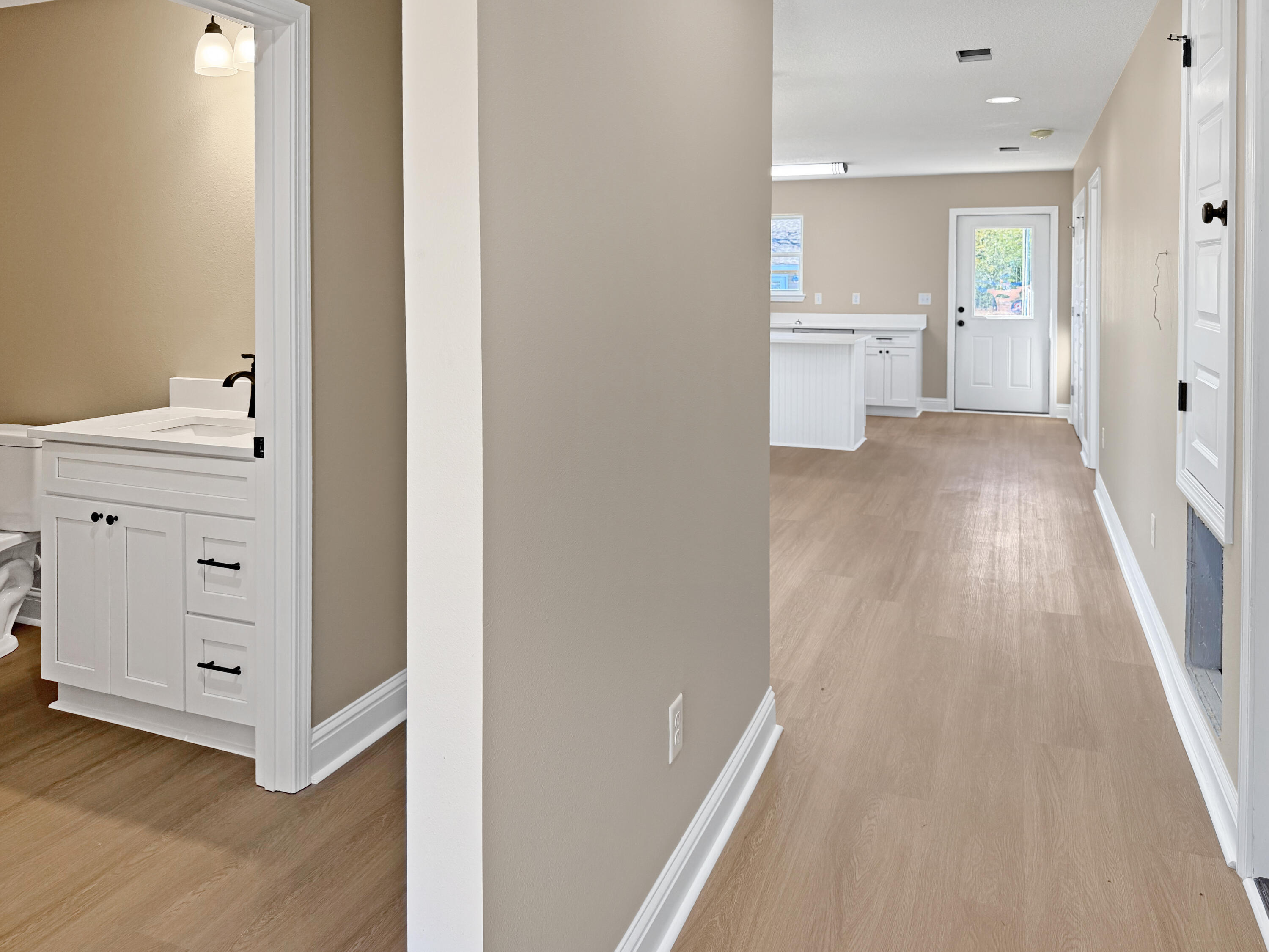 5356 Highview Drive Crestview, FL 32539 - Photo 7 of 18 a view of a hallway with bathroom and wooden floor