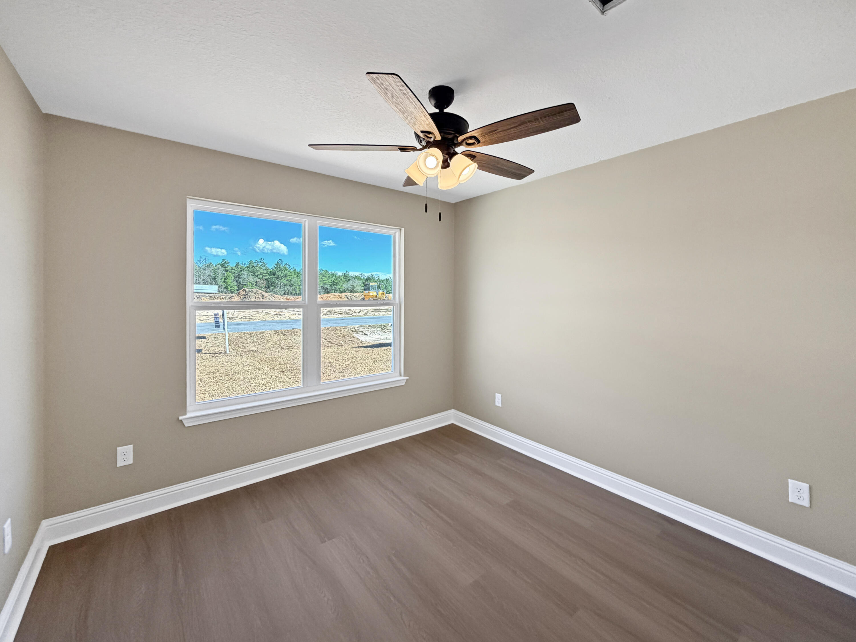 5356 Highview Drive Crestview, FL 32539 - Photo 8 of 18 an empty room with wooden floor fan and windows