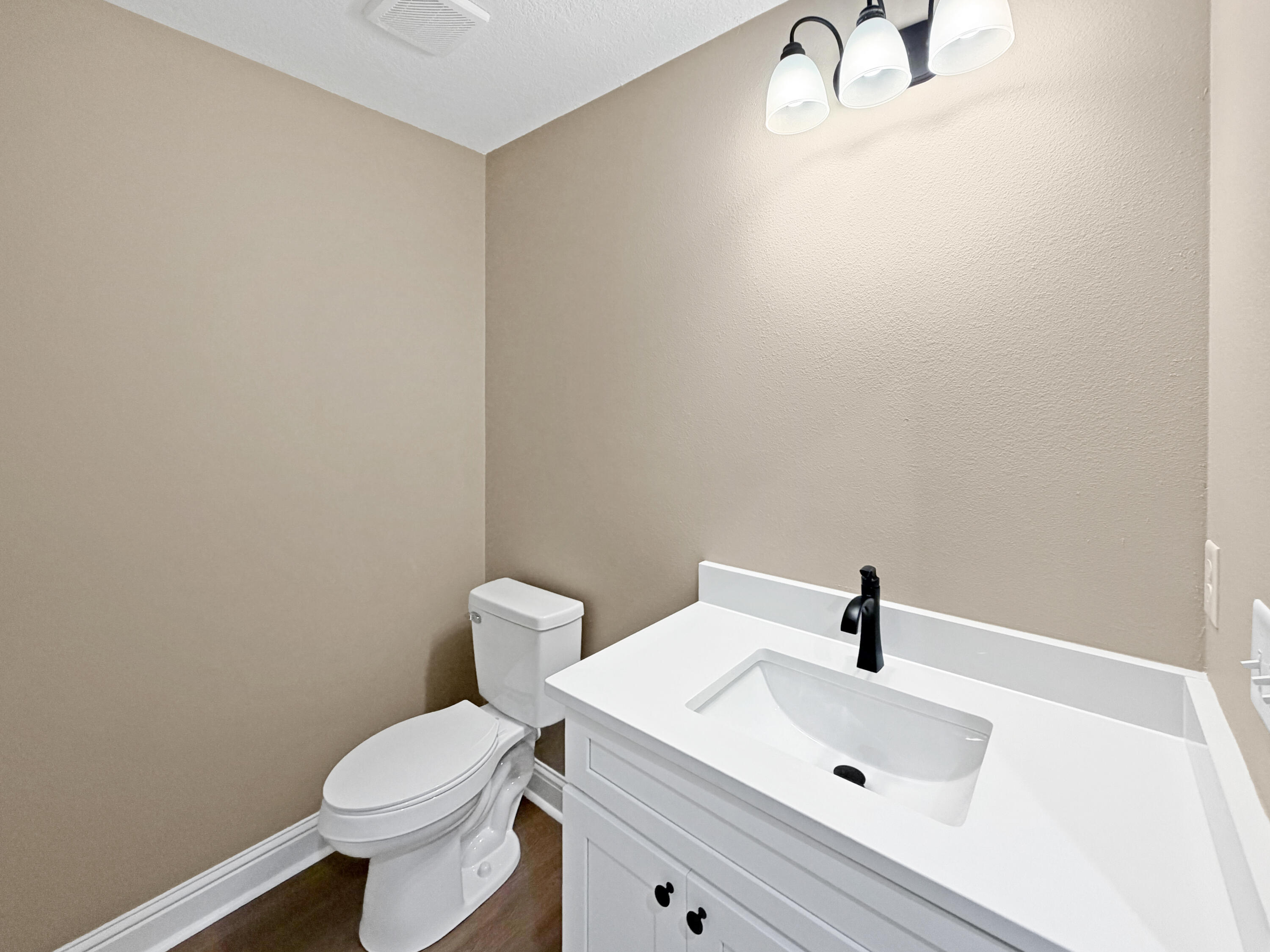 5356 Highview Drive Crestview, FL 32539 - Photo 10 of 18 a white toilet sitting next to a bathroom sink