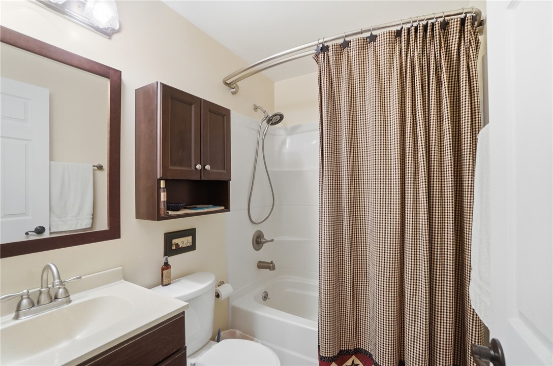 4170 Johnson Road Springfield, OH 45502 - Photo 49 of 54 Functional full bathroom featuring a tub-shower combination, a vanity with a mirror, and ample storage.