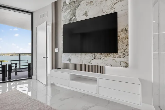 a bathroom with a bathtub and a walk in closet