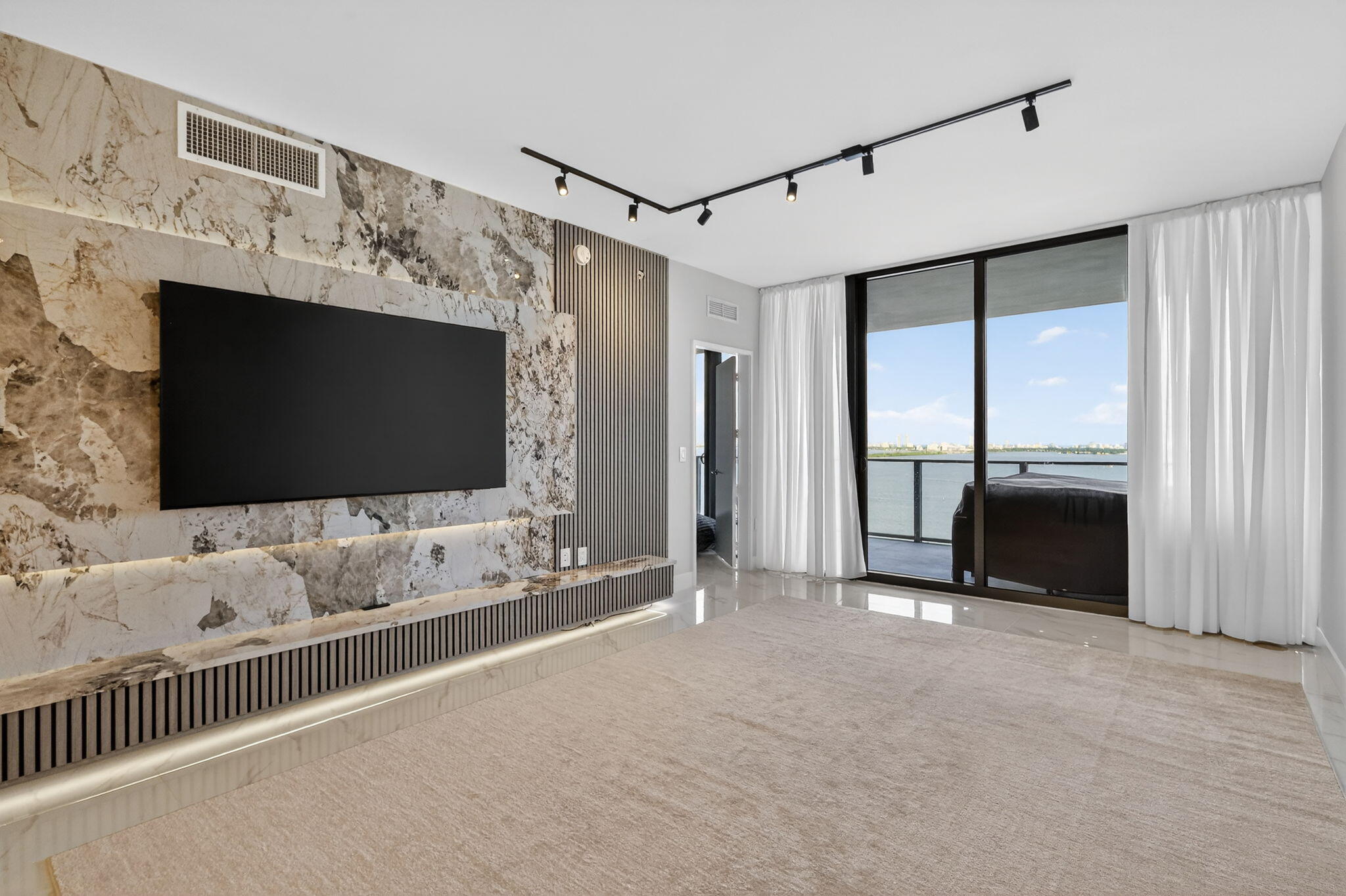 700 Northeast 23rd Street, Unit 2006 Miami, FL 33137 - Photo 11 of 34 a living room with a flat screen tv and a fireplace