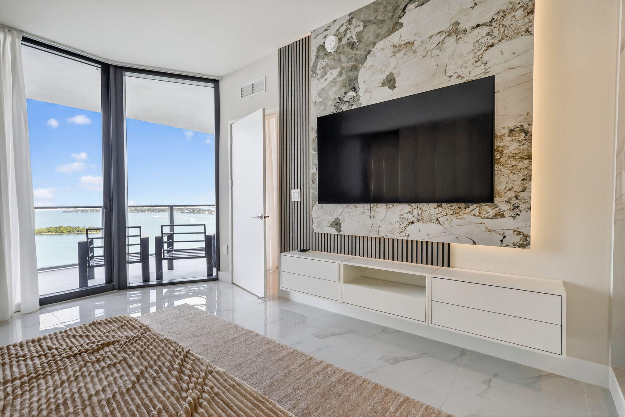 700 Northeast 23rd Street, Unit 2006 Miami, FL 33137 - Photo 14 of 34 a bathroom with a sink a mirror and a bathtub