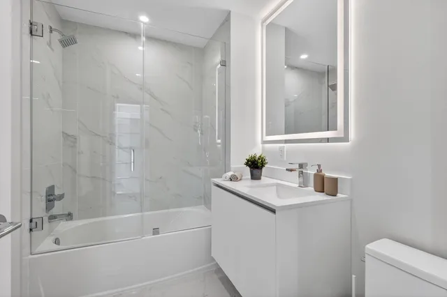 a bathroom with a sink toilet and shower