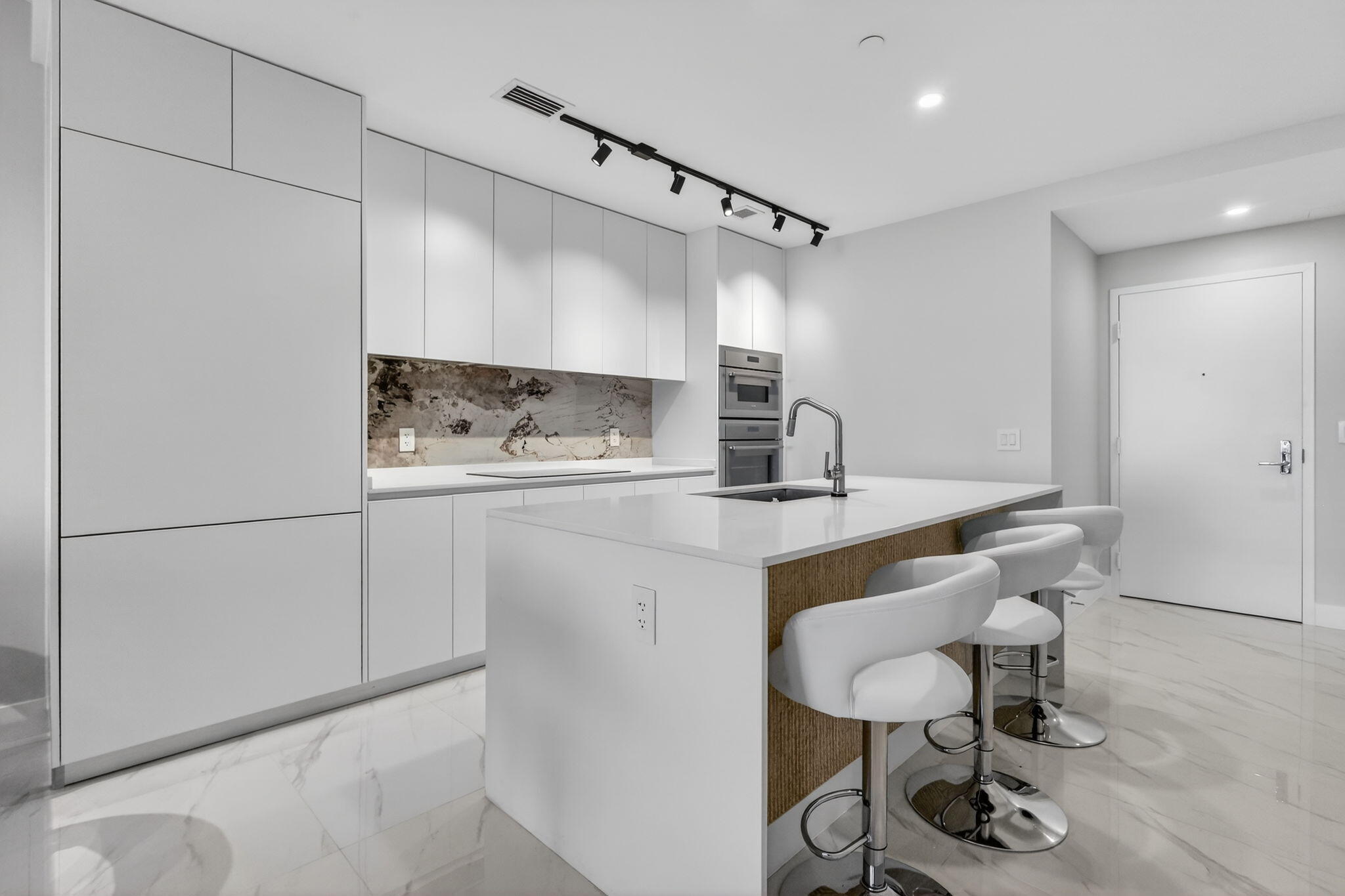 700 Northeast 23rd Street, Unit 2006 Miami, FL 33137 - Photo 6 of 34 a kitchen with stainless steel appliances granite countertop a sink and a refrigerator