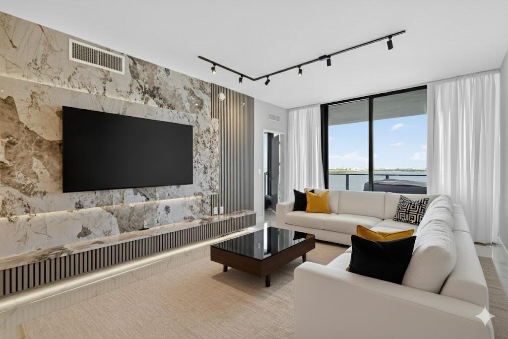 700 Northeast 23rd Street, Unit 2006 Miami, FL 33137 - Photo 7 of 34 a living room with furniture and a flat screen tv