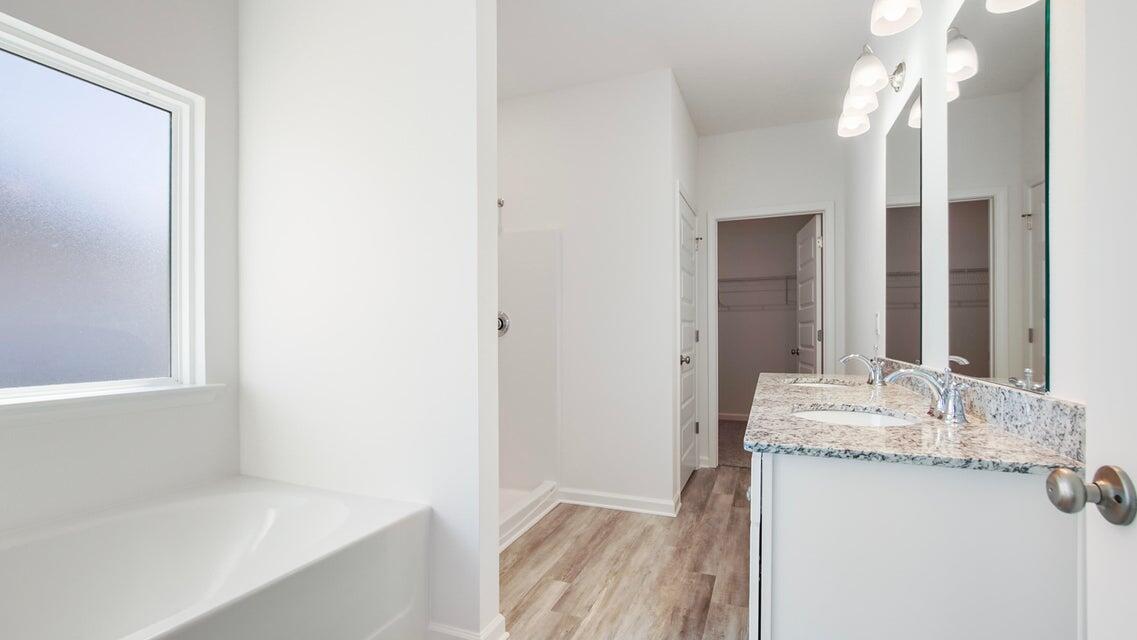 181 Huckleberry Street Freeport, FL 32439 - Photo 6 of 14 a bathroom with a granite countertop sink and a mirror