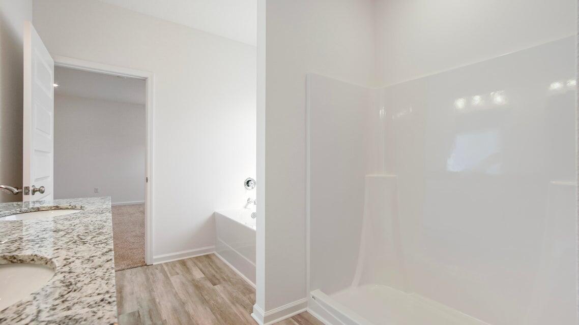 181 Huckleberry Street Freeport, FL 32439 - Photo 8 of 14 a bathroom with a granite countertop sink and a mirror