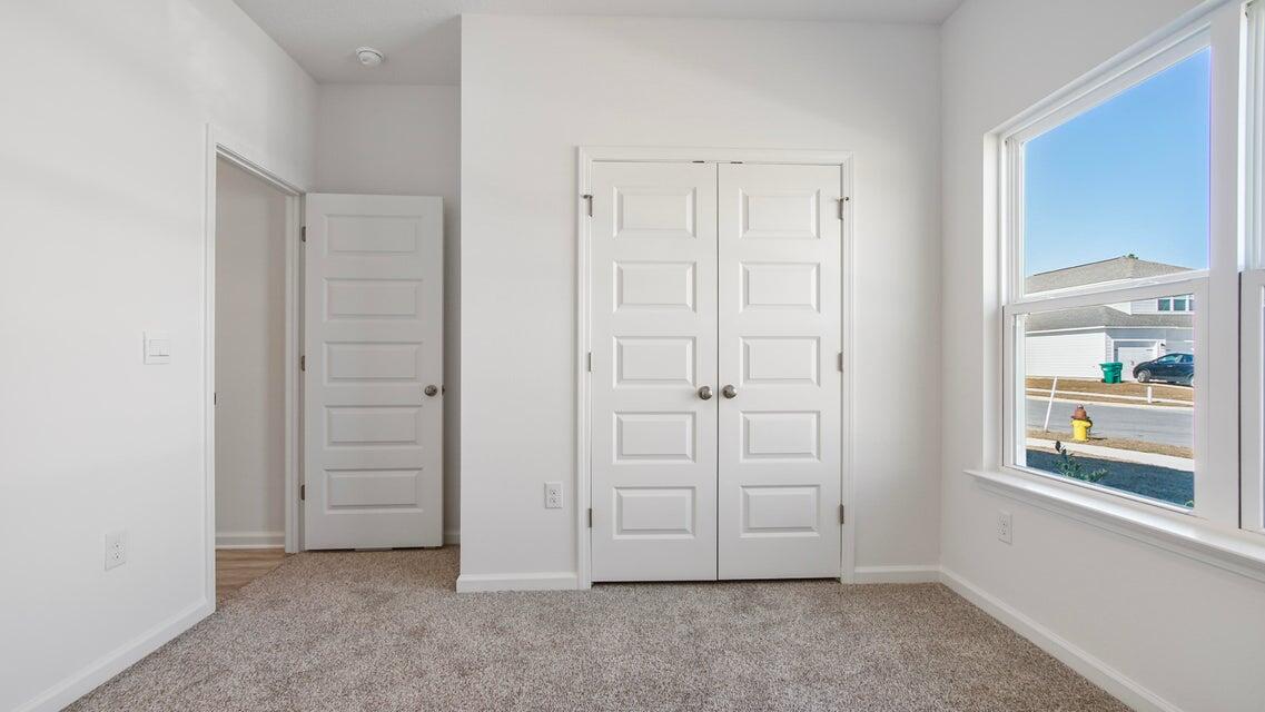 181 Huckleberry Street Freeport, FL 32439 - Photo 10 of 14 an empty room with windows cabinet and door