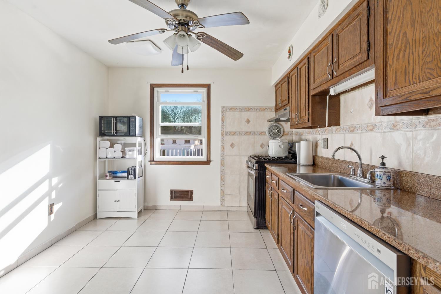 160 Stratton Street South Piscataway, NJ 08854 - Photo 15 of 31 a kitchen with stainless steel appliances granite countertop a sink stove and refrigerator