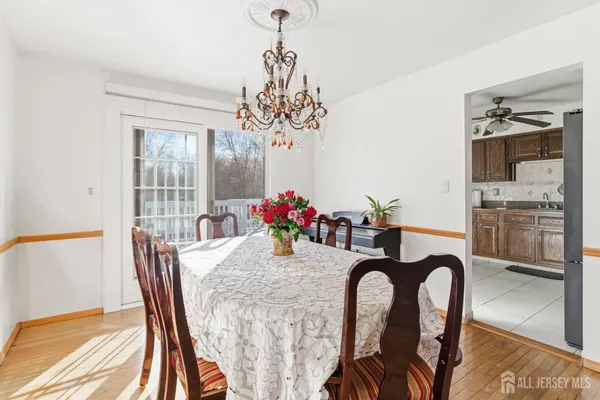 a view of a dining room with furniture wooden floor and a chandelier
