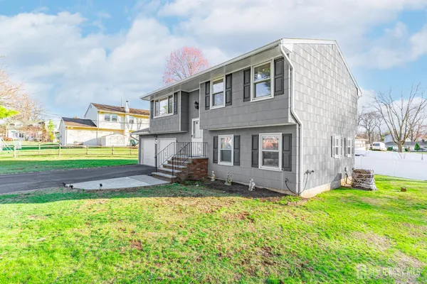 a backyard of a house with table and chairs
