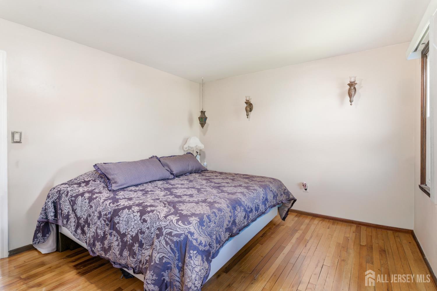 160 Stratton Street South Piscataway, NJ 08854 - Photo 23 of 31 a bedroom with a bed and wooden floor