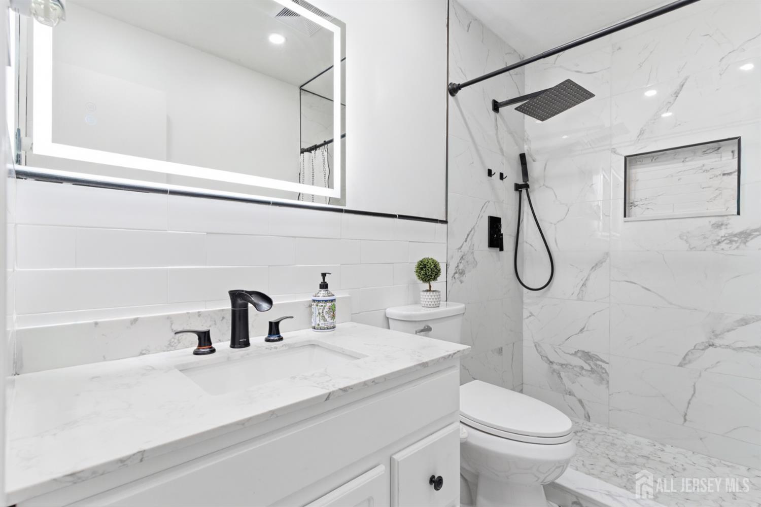 160 Stratton Street South Piscataway, NJ 08854 - Photo 24 of 31 a bathroom with a sink a toilet and shower