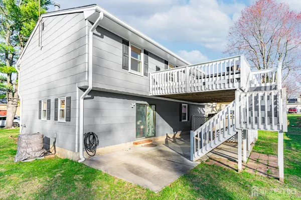 a view of a house with a yard and deck