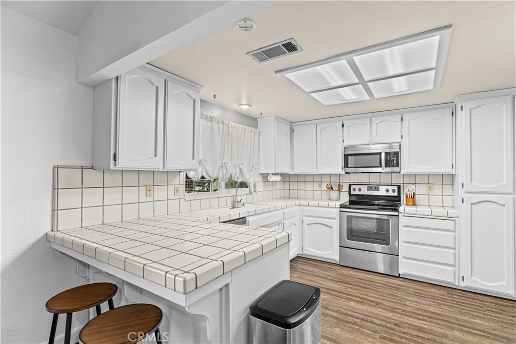 3585 Cabrillo Court Merced, CA 95348 - Photo 13 of 42 a kitchen with a stove sink and cabinets