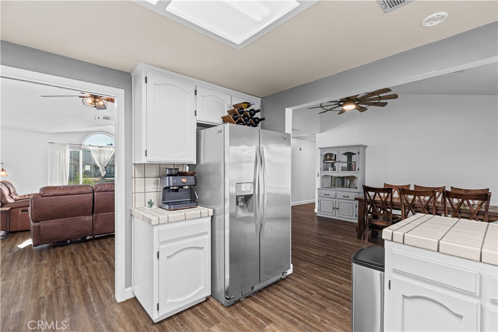 3585 Cabrillo Court Merced, CA 95348 - Photo 16 of 42 a kitchen with a refrigerator and a couch