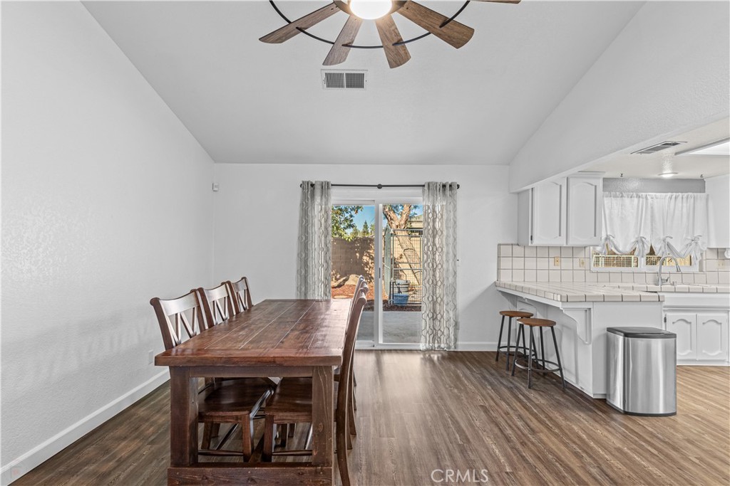 3585 Cabrillo Court Merced, CA 95348 - Photo 19 of 42 a view of a dining room with furniture window and wooden floor