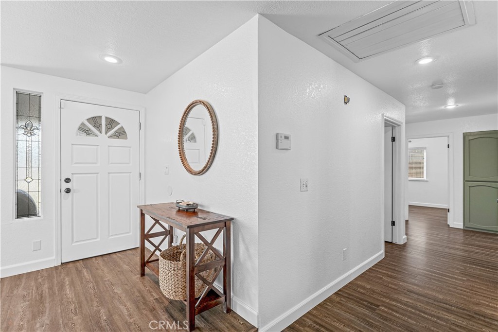 3585 Cabrillo Court Merced, CA 95348 - Photo 21 of 42 a view of a hallway with wooden floor and furniture