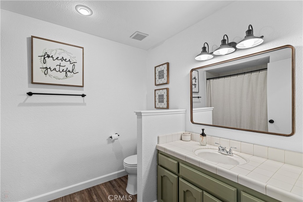 3585 Cabrillo Court Merced, CA 95348 - Photo 25 of 42 a bathroom with a toilet sink and mirror