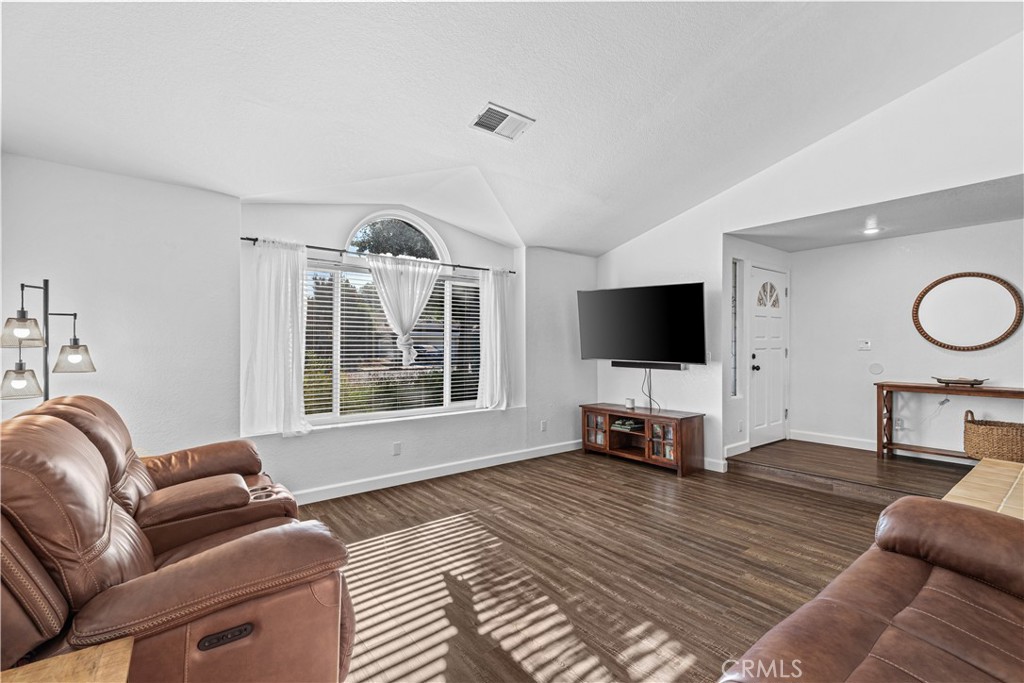3585 Cabrillo Court Merced, CA 95348 - Photo 9 of 42 a living room with furniture a flat screen tv and a large window