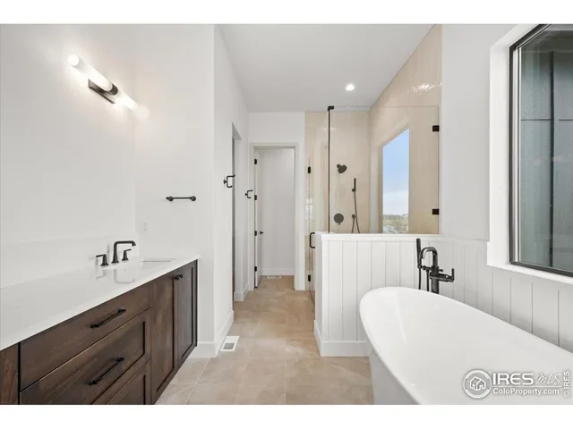 a bathroom with a sink a mirror and a bathtub