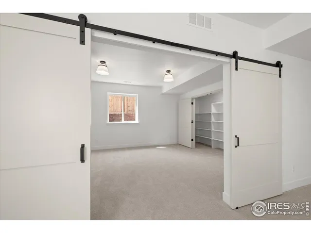 a view of a big room with closet and windows