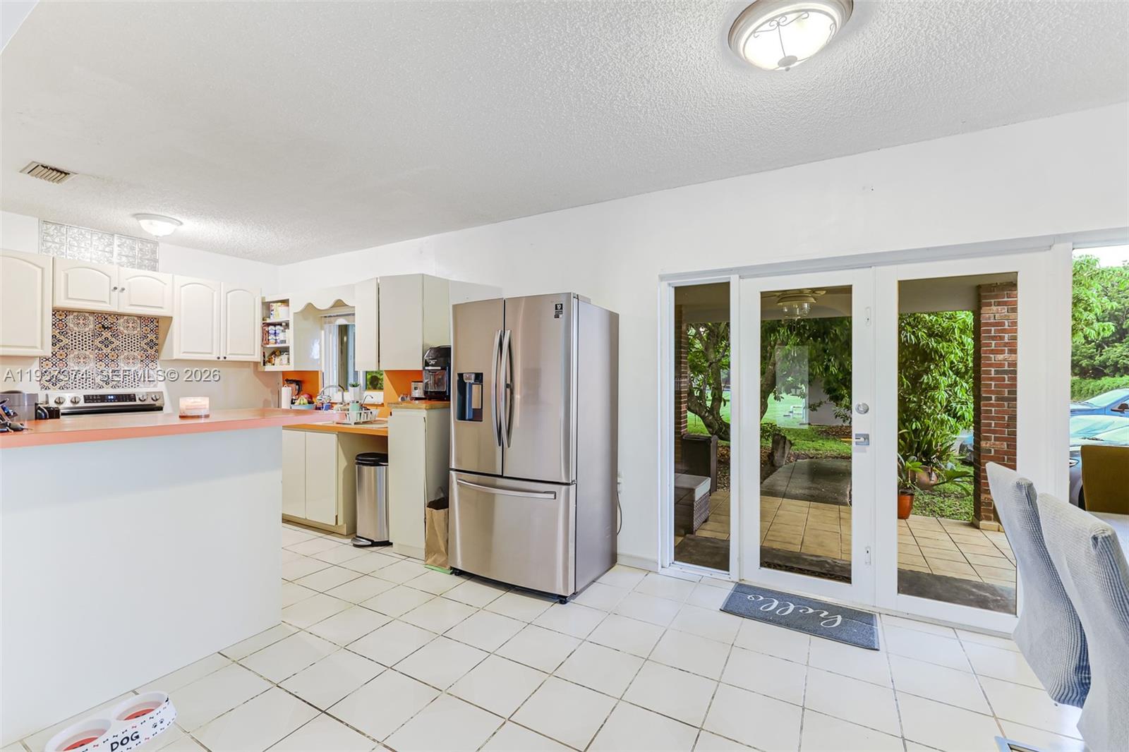 20890 Southwest 236th Street Homestead, FL 33031 - Photo 22 of 47 a kitchen with white cabinets and refrigerator