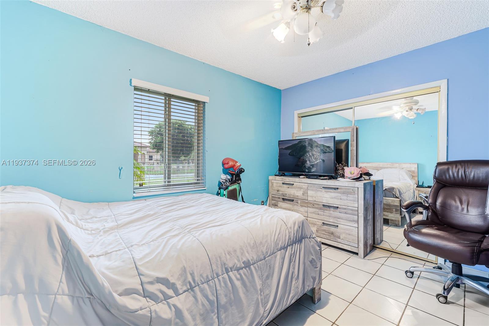 20890 Southwest 236th Street Homestead, FL 33031 - Photo 28 of 47 a bedroom with a large bed and flat screen tv