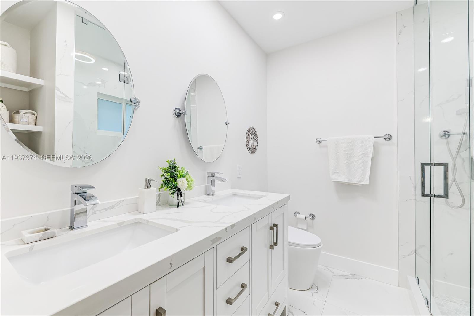 20890 Southwest 236th Street Homestead, FL 33031 - Photo 32 of 47 a bathroom with a double vanity sink mirror and toilet