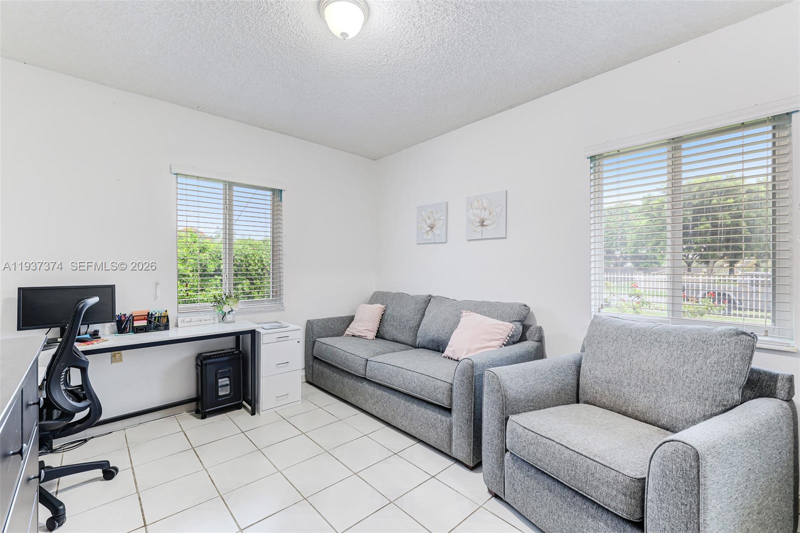 20890 Southwest 236th Street Homestead, FL 33031 - Photo 33 of 47 a living room with furniture and a large window