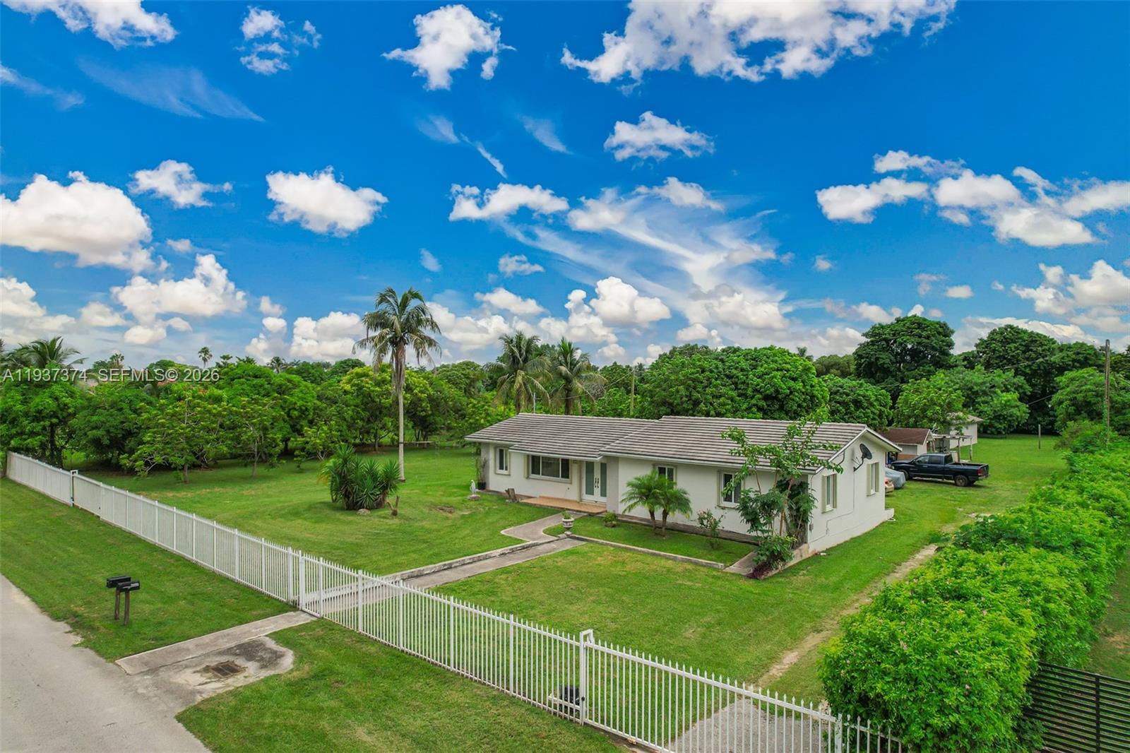 20890 Southwest 236th Street Homestead, FL 33031 - Photo 5 of 47 a view of a house with a big yard