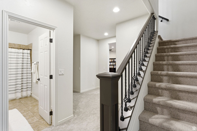 1712 Somerset Ridge Drive Draper, UT 84020 - Photo 52 of 76 Carpeted staircase with an ornamental wrought iron and wood-finish railing