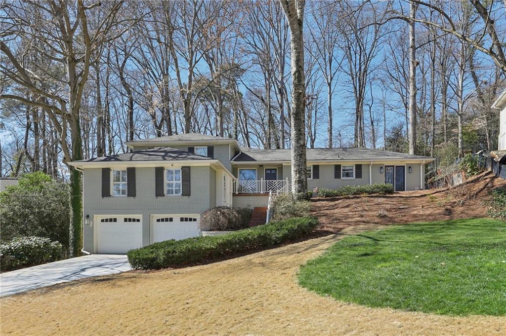 3902 Sheldon Drive Northeast Atlanta, GA 30342 - Photo 1 of 1 a front view of a house with a garden