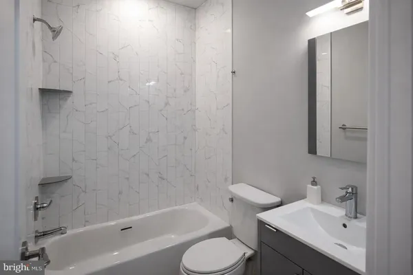 a bathroom with a sink toilet and bathtub