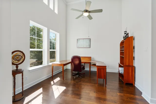 a view of a workspace with furniture and a window
