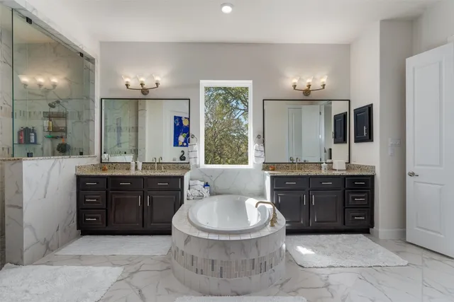 a bathroom with a granite countertop toilet sink and mirror